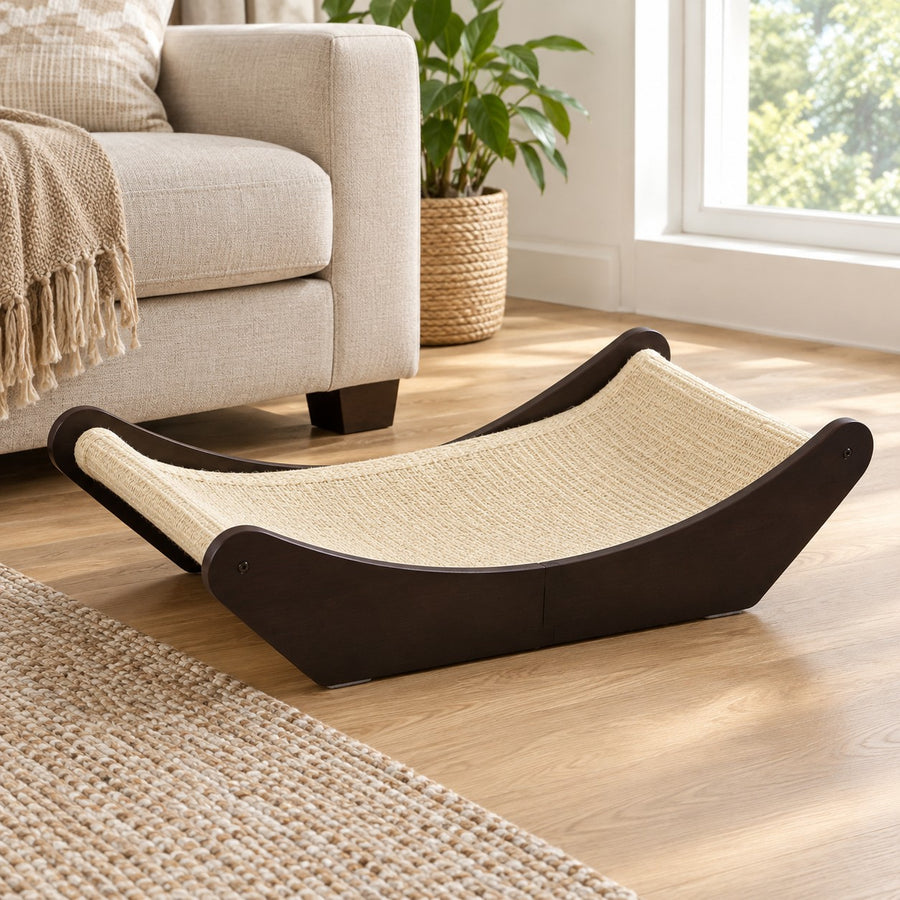 Dark wood cat scratcher lounge bed with natural sisal mat in a living room
