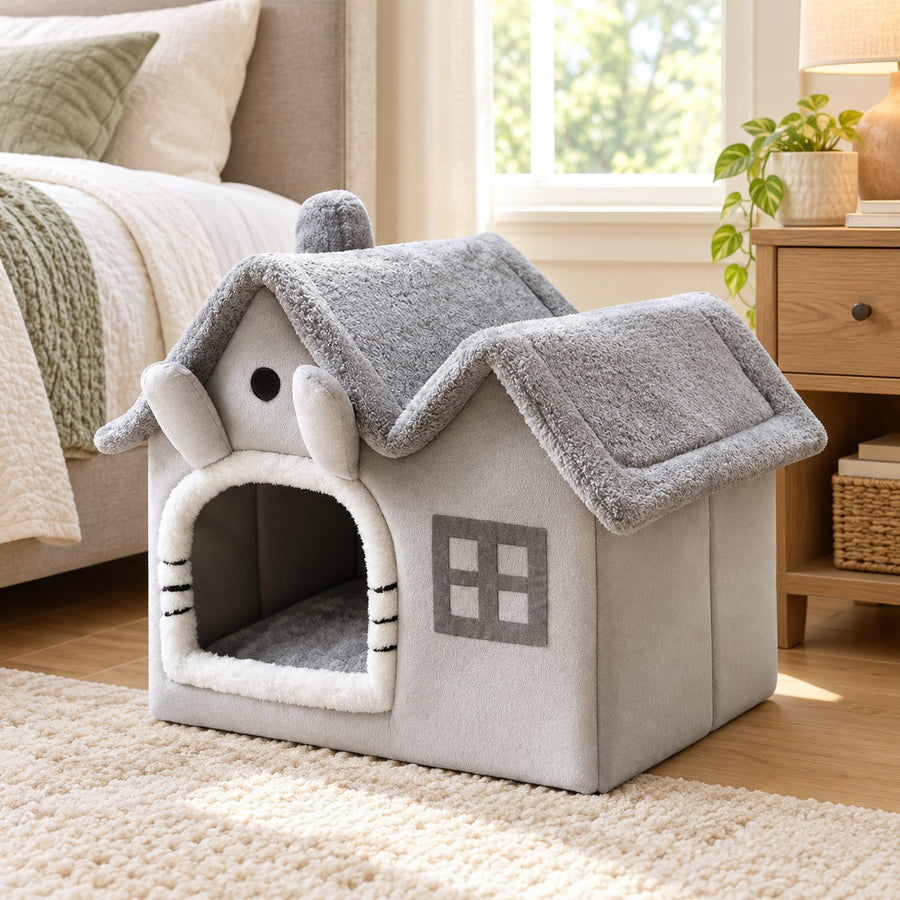 Grey plush indoor dog house with double roof in a bedroom
