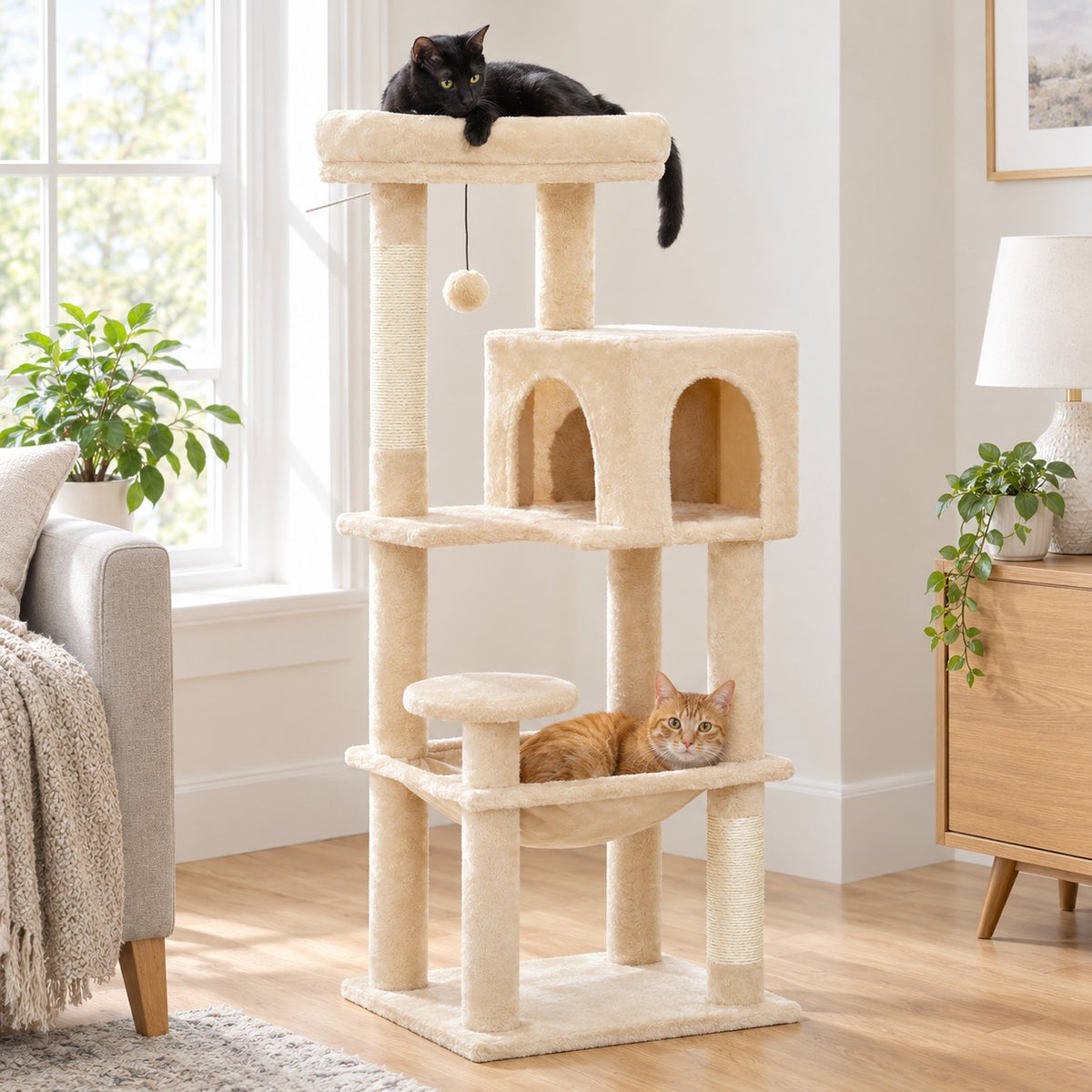 Cat lying in the hammock of a beige 44.5 in cat tree, another cat on the top perch