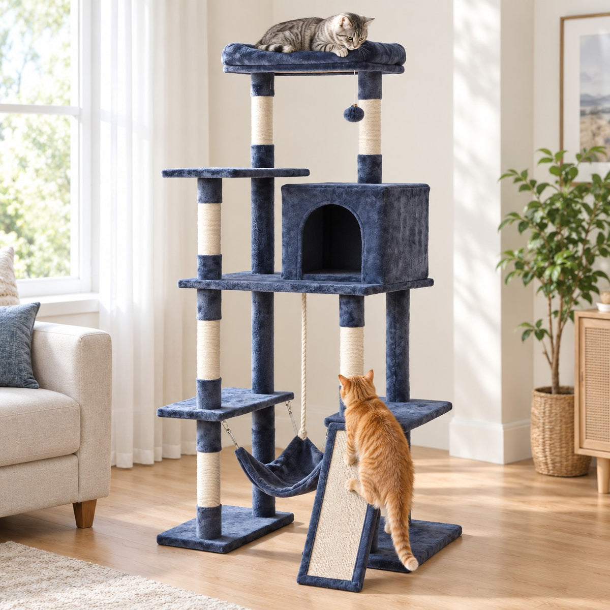 Cat lying on the top perch of a 63 in blue-grey cat tree, a second cat walking up the scratching ramp