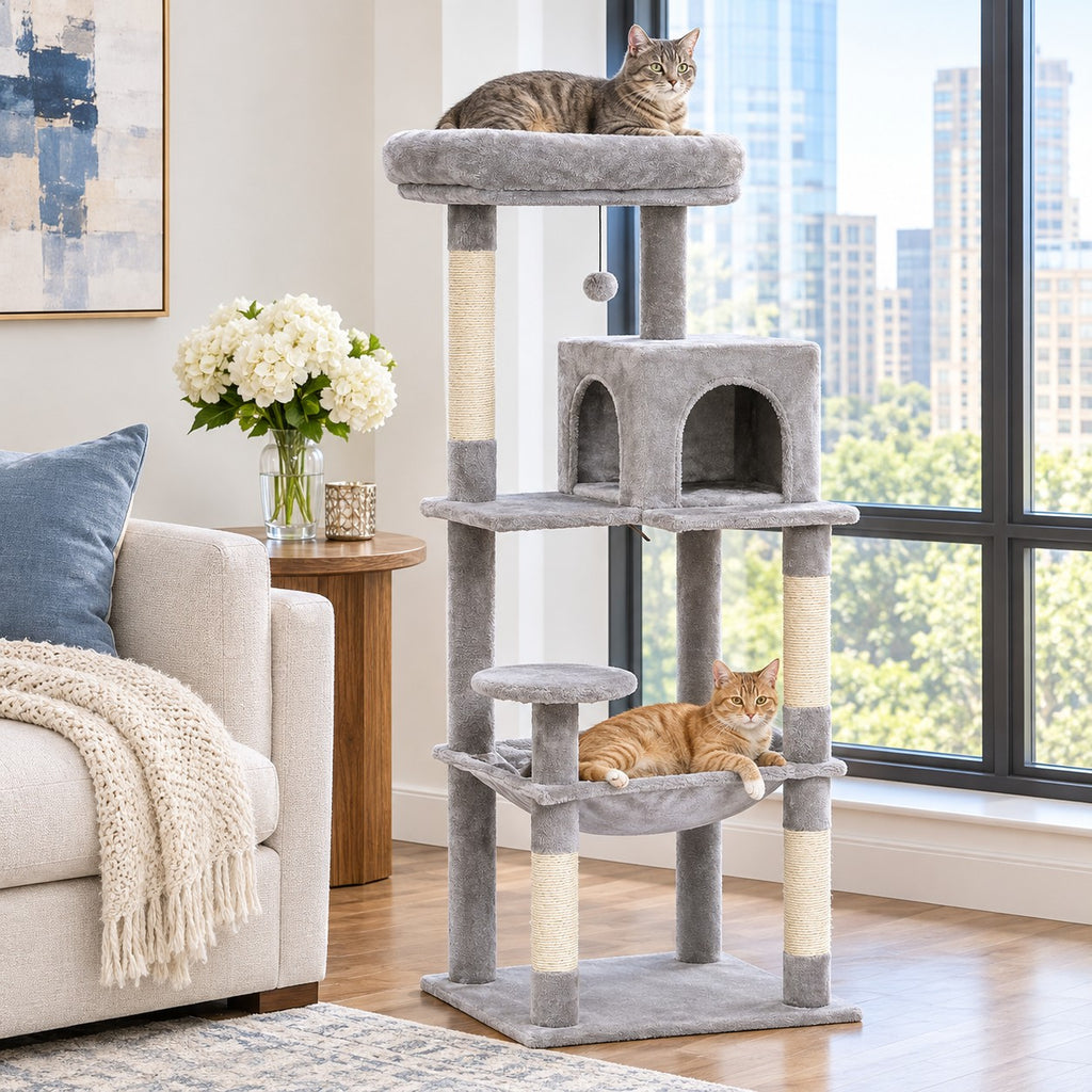 Cat lying on the top perch of a light grey cat tree while another cat rests in the hammock