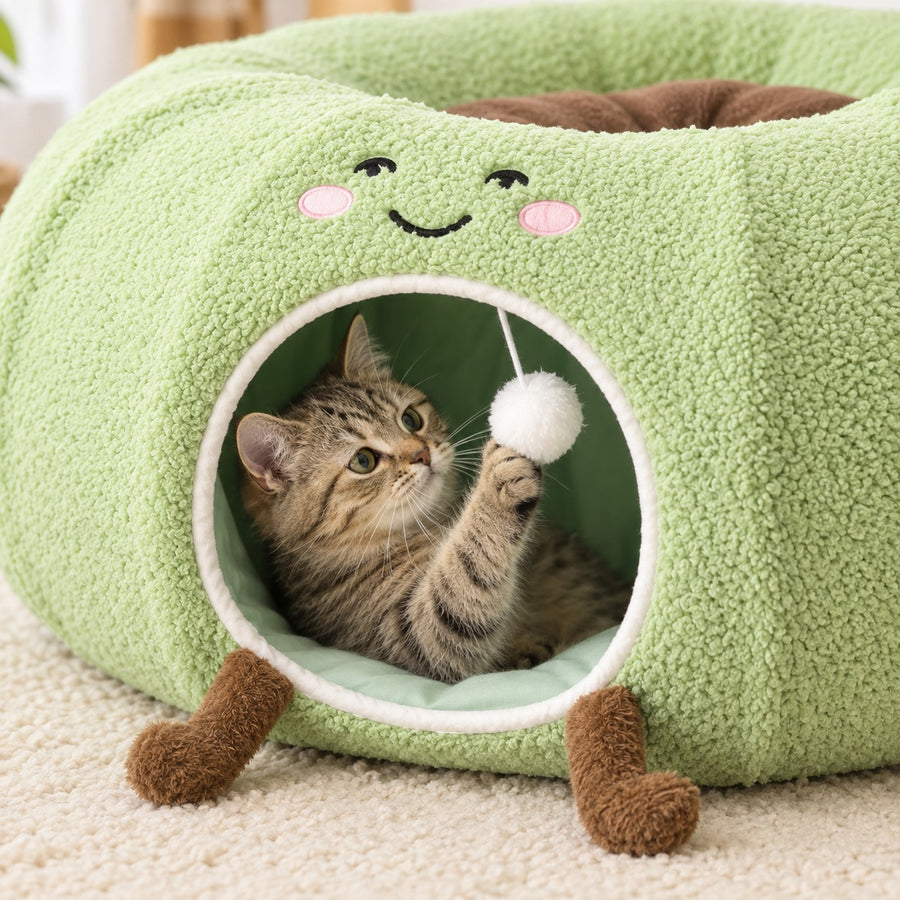 Cat reaching for the pom-pom in the front entrance of the cat tunnel bed
