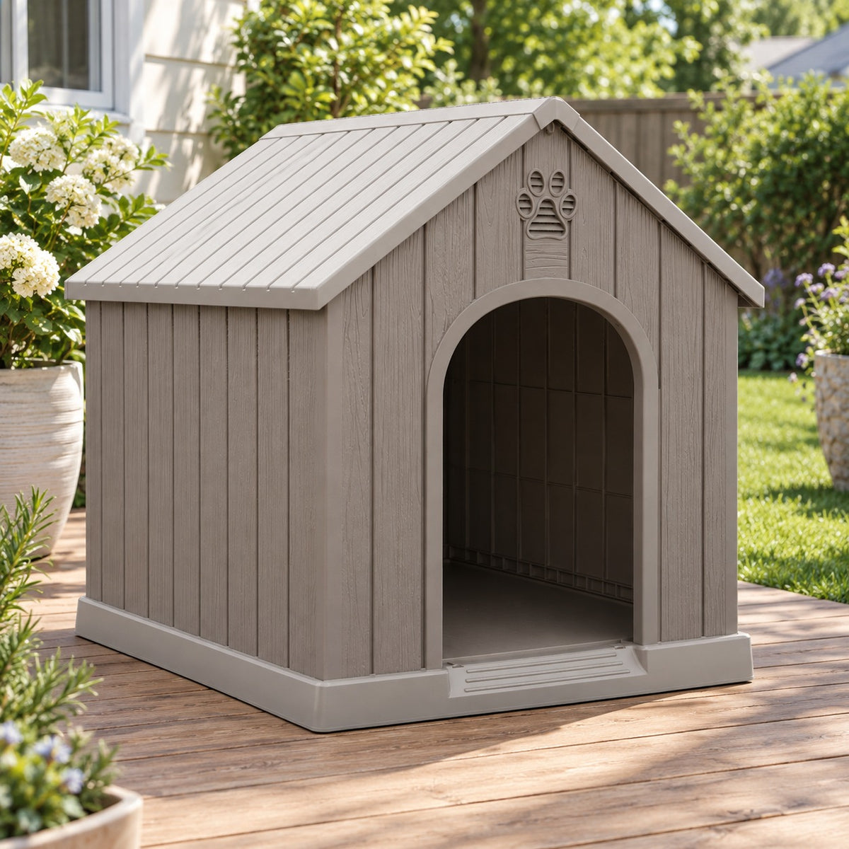 Gray plastic dog house for small dogs with raised floor on a backyard deck