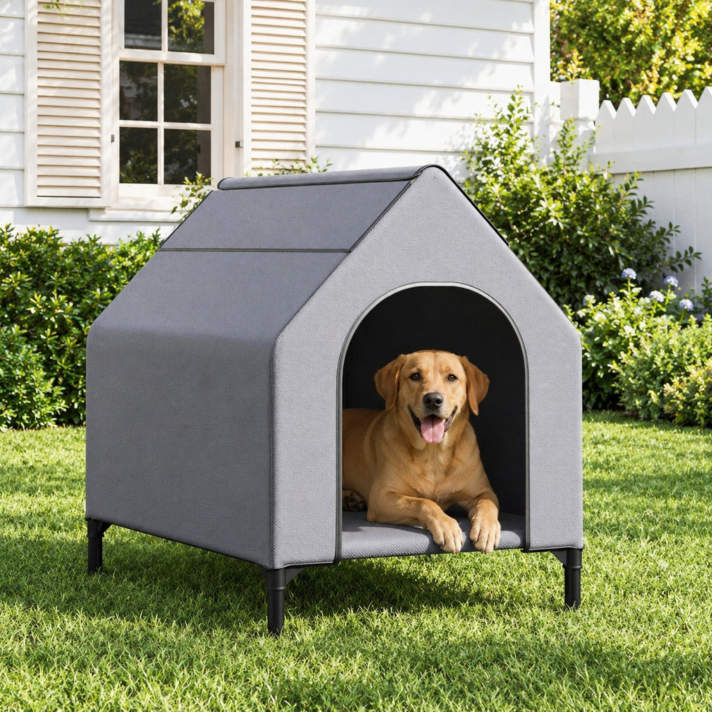 Dog lying in an elevated grey dog house on a backyard lawn
