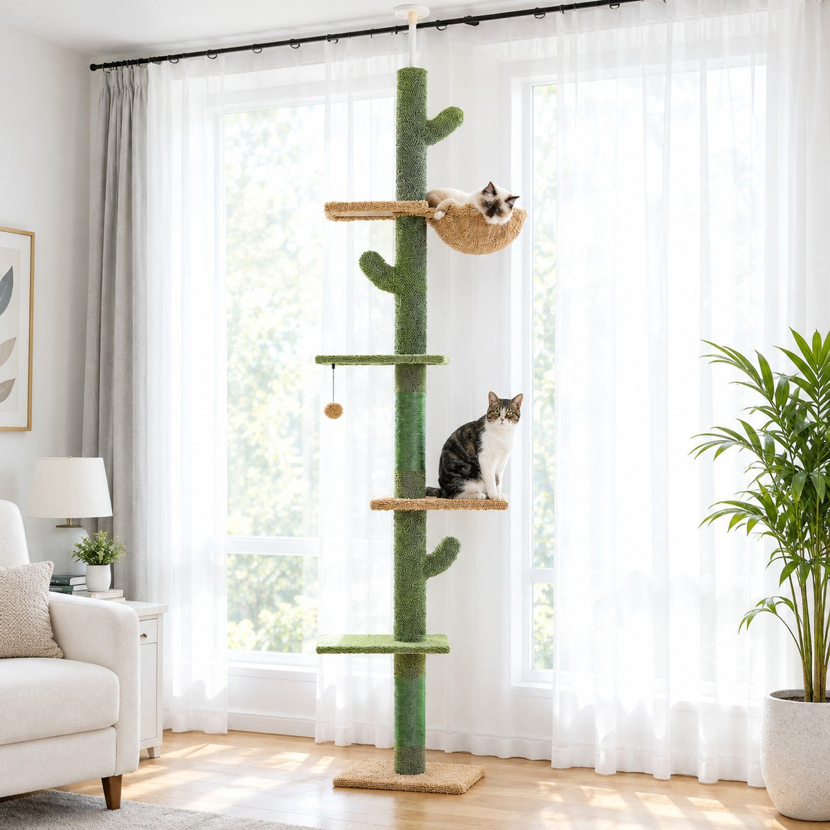 Cat curled in the basket bed of a floor-to-ceiling cactus cat tree while another cat sits on a platform