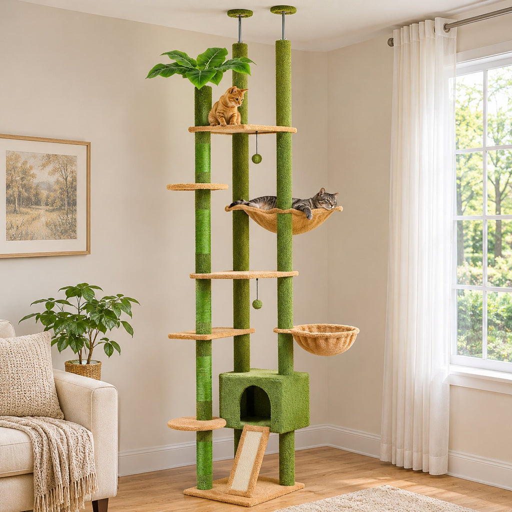 Cat lying in the hammock of a green floor to ceiling cat tree, a second cat on the top platform