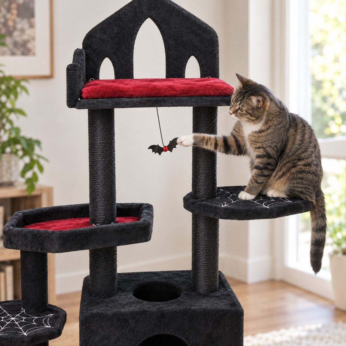 Cat batting the bat-shaped toy of the gothic cat tree