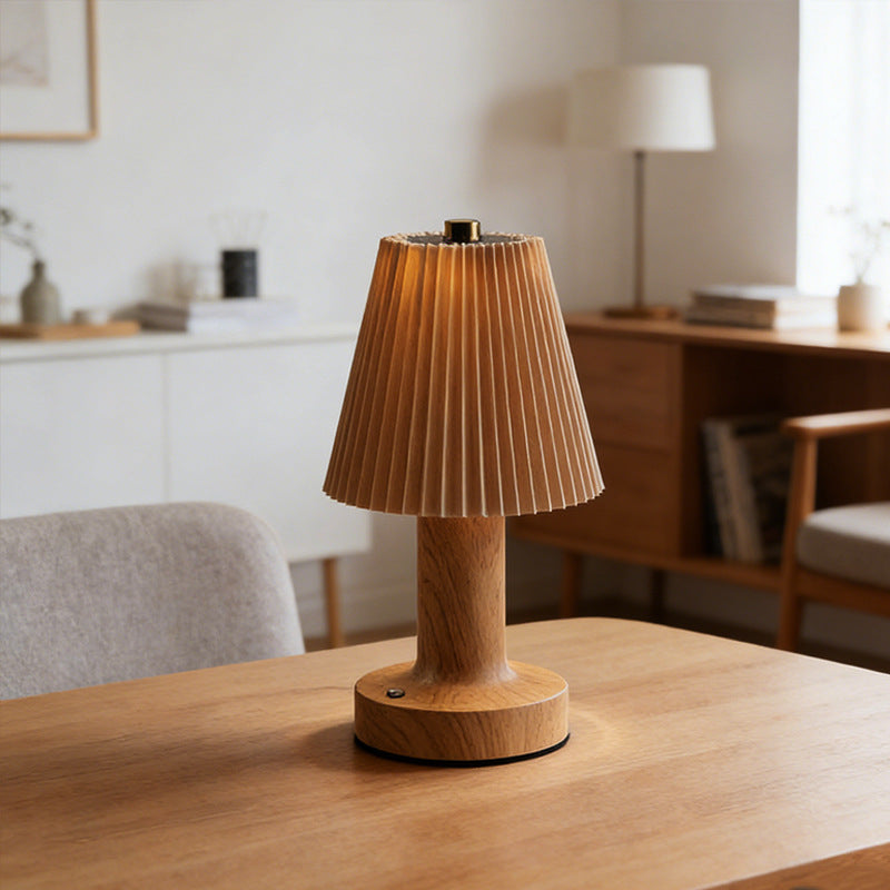 Rechargeable mushroom lamp lit warm white on a nightstand