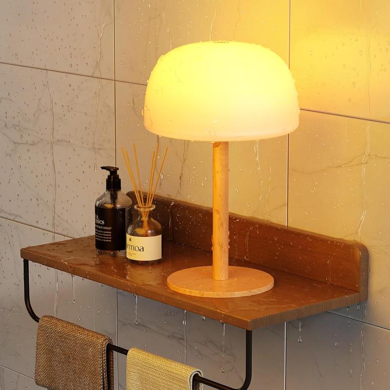 Cordless mushroom lamp glowing warm on a bathroom shelf next to the shower Image