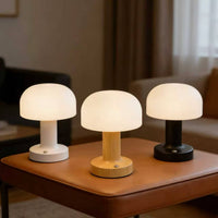 Mushroom lamp in white, wood and black finishes on a leather bench