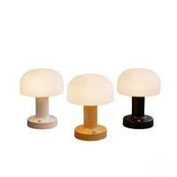 Three cordless mushroom lamps in white, wood grain and black finishes